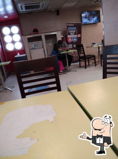 Take a seat at one of the tables at Domino's Pizza Howrah AC Market, Howrah