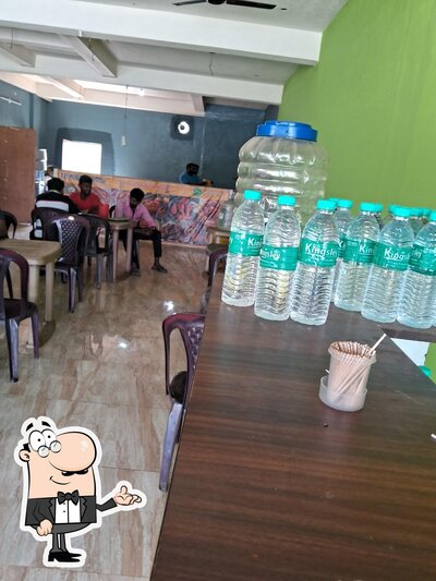 Take a seat at one of the tables at Chithra Mess &Fast Food சித்ரா மெஸ் &பாஸ்ட் புட்