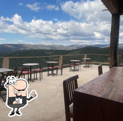 Sente em uma das mesas no Bar e Espeteria do Claudinho