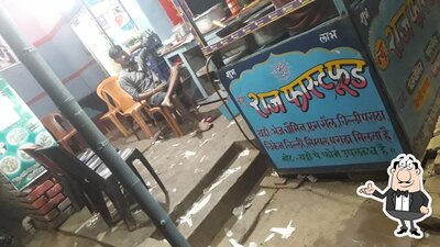 Take a seat at one of the tables at New Raj Fast Food