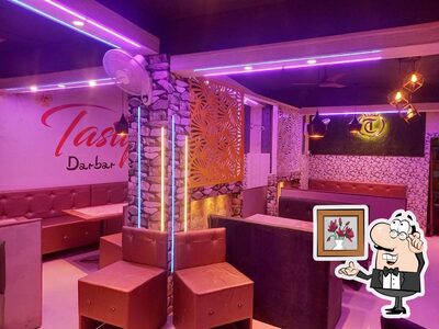 Take a seat at one of the tables at Tasty chicken Corner and Tasty Darbar family hotel