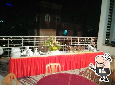 Take a seat at one of the tables at Status Restaurant Bar Banquets