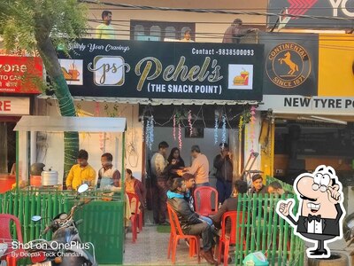 Take a seat at one of the tables at Pehel's (The Snack Point)