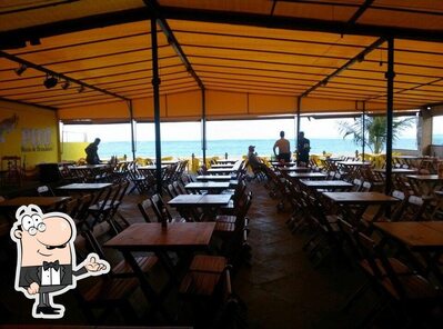 Sente em uma das mesas no Caravelas Bar e Restaurante