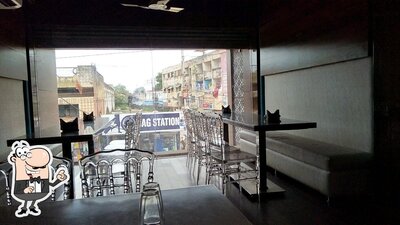 Take a seat at one of the tables at Tripti Restaurant & Fast Food