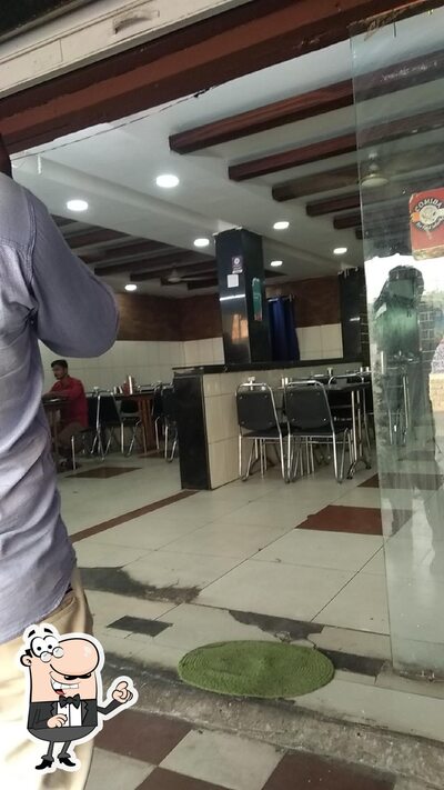 Take a seat at one of the tables at Akshay Family Restaurant & Fast Food