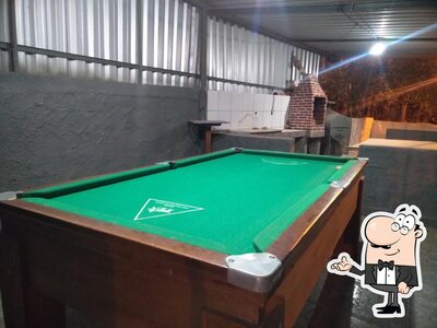 Sente em uma das mesas no Bar do Solidão