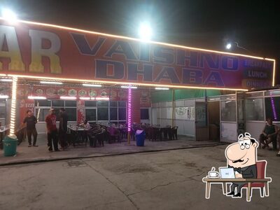 Take a seat at one of the tables at SAI GOLDEN VAISHNO DHABA
