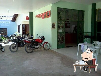 Sente em uma das mesas no O Rei da Pamonha - Alta floresta MT