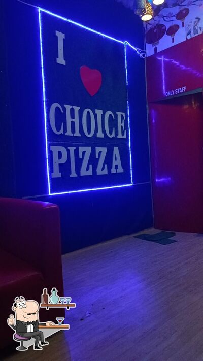 Take a seat at one of the tables at Choice pizza behal