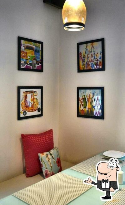 Take a seat at one of the tables at Little India Multi Cuisine Restaurant