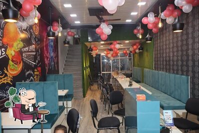 Take a seat at one of the tables at Anshika Family restaurant
