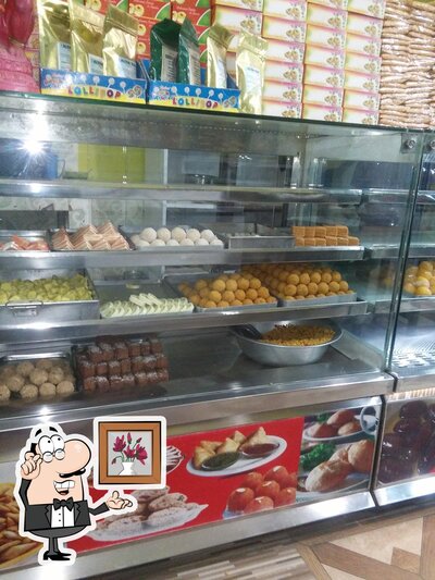 Take a seat at one of the tables at Shivam Sweet House