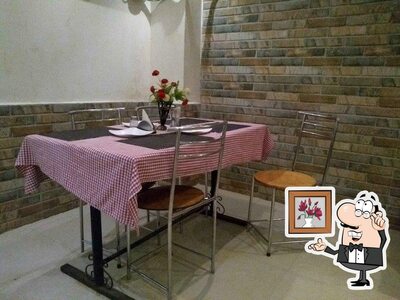 Take a seat at one of the tables at Arya Mahal Restaurant