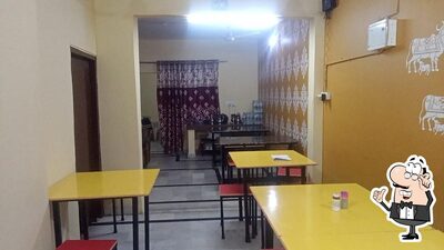 Take a seat at one of the tables at Maa Bhagwati Rasoi