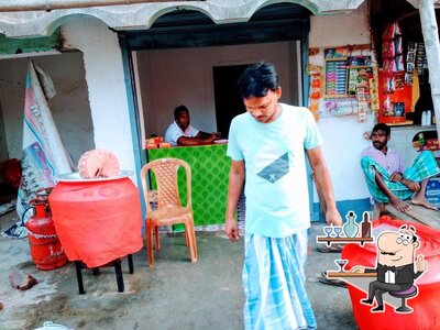 Take a seat at one of the tables at পারভিন বিরিয়ানি হাউস