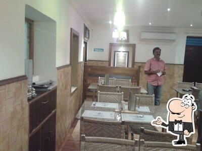 Take a seat at one of the tables at Nirmala Treditional Restuarant