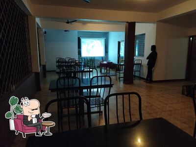 Take a seat at one of the tables at Greenland Bar & Family Restaurant