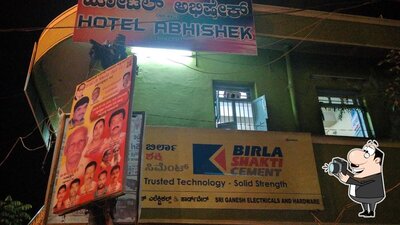 The advertisement displays information about Hotel Abhishek