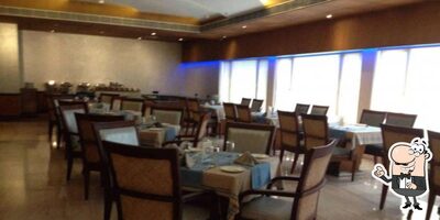 Take a seat at one of the tables at Diana Heights Multicuisine Restaurant