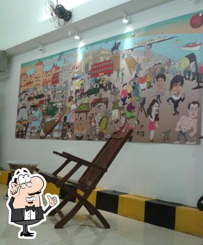 Take a seat at one of the tables at Mumbai Tadka- The Food Lounge