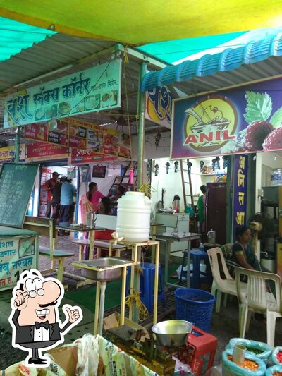Take a seat at one of the tables at Hotel Yash Snacks Corner