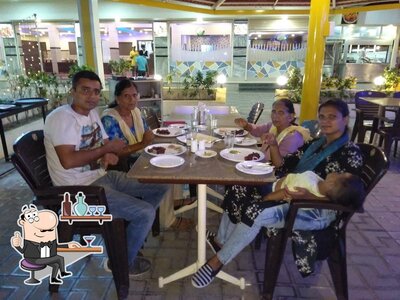 Take a seat at one of the tables at HOTEL FOOD N FUN