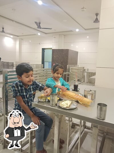 Take a seat at one of the tables at AmarKunj Restorant