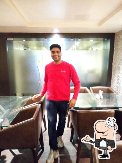 Take a seat at one of the tables at Goutam Hotel