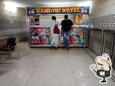 Take a seat at one of the tables at Nandini Hotel