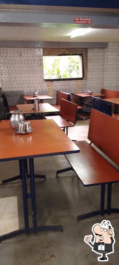 Take a seat at one of the tables at Kadamba Veg Restaurant