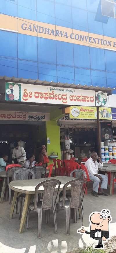 Take a seat at one of the tables at Sri Raghavendra Hotel