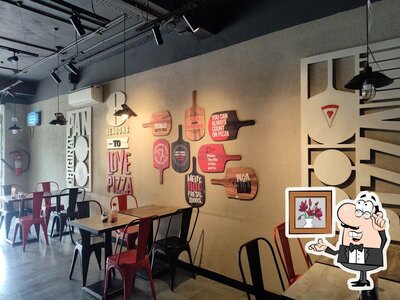 Take a seat at one of the tables at Pizza Hut Parvathi Nagar, Bellary