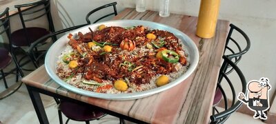 Take a seat at one of the tables at റൊട്ടാന റെസ്റ്റോറന്റ്