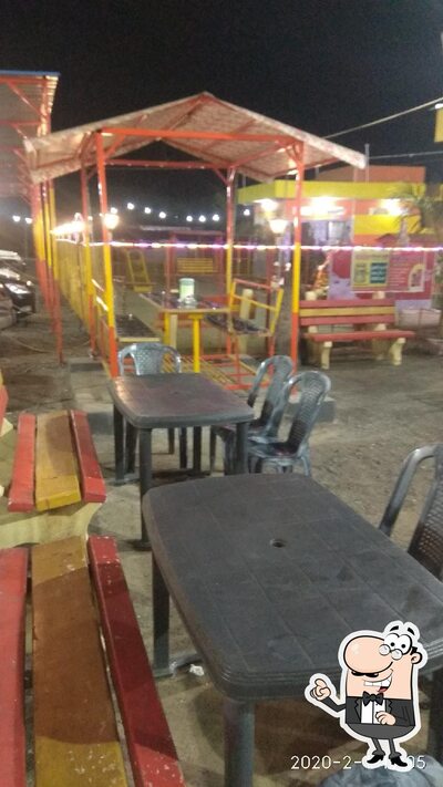 Take a seat at one of the tables at Shanti Dhaba & Family Restaurant (Pure Veg)