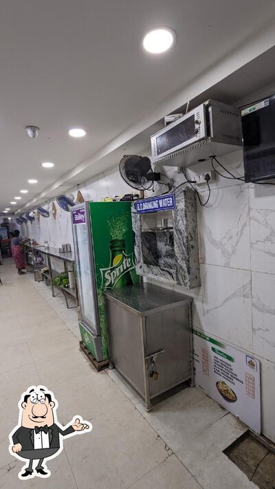 Take a seat at one of the tables at Surya Fast Food And Tiffin Centre