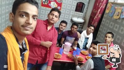 Take a seat at one of the tables at Nishu Chainiz Fast Food Corner