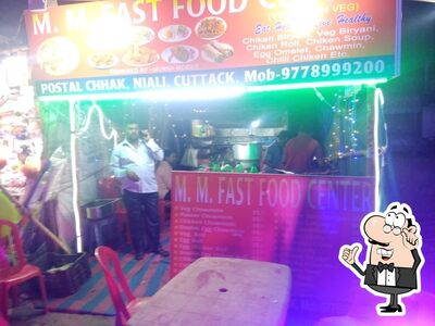 Take a seat at one of the tables at M.M. FAST FOOD CENTERE