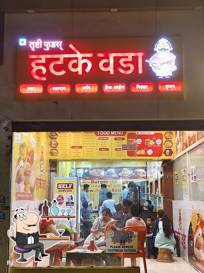 Take a seat at one of the tables at Hatke Vada Trushti Food's