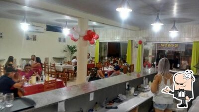 Sente em uma das mesas no Xis Gaúcho - Sabor & Arte