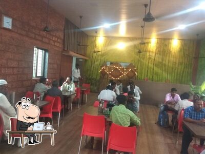 Take a seat at one of the tables at नैवेद्य