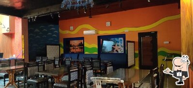 Take a seat at one of the tables at Fish Andhra - Lounge
