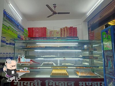 Take a seat at one of the tables at Gaytri Sweets and Fast Food