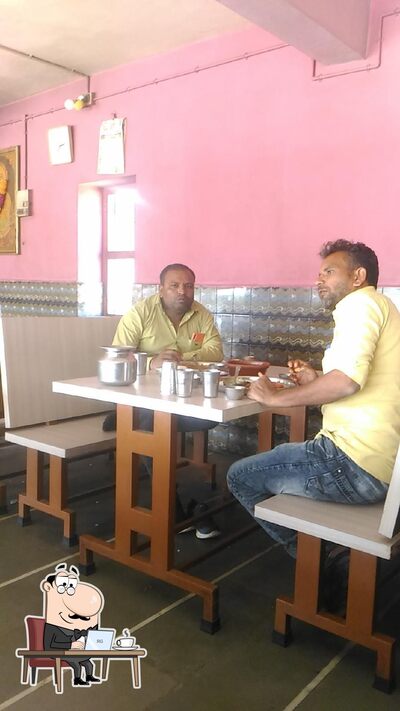 Take a seat at one of the tables at M.K. Mevada Hotel