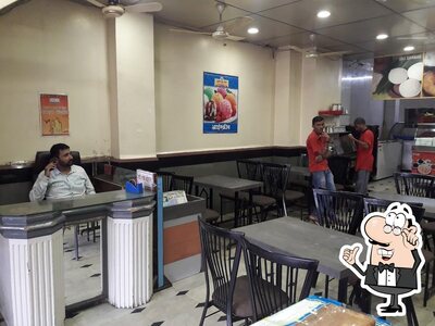 Take a seat at one of the tables at RASRAJ (Gol bazaar)