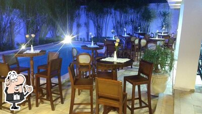 Sente em uma das mesas no Cave Adega e Bar