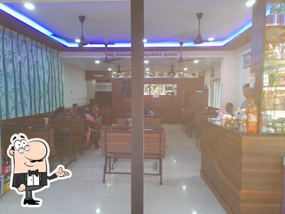Take a seat at one of the tables at Dream Tea Pure Veg Restaurant