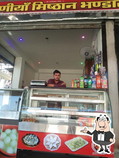 Take a seat at one of the tables at Jogniya Misthan Bhandar