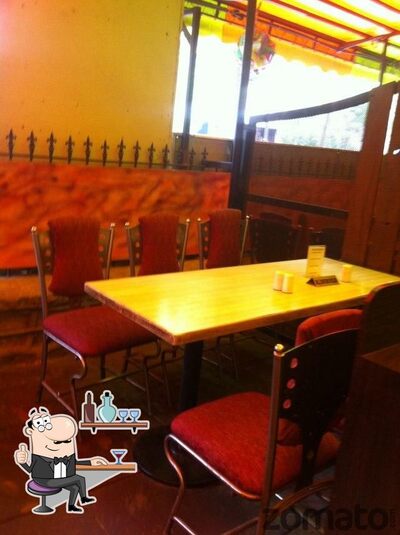 Take a seat at one of the tables at Spice Up Veg Restaurant