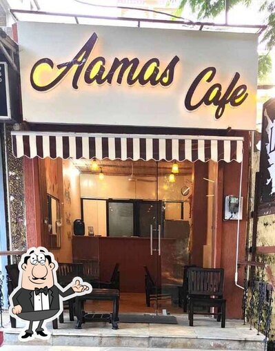 Take a seat at one of the tables at Aamas Cafe